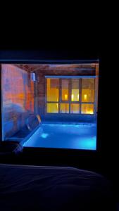 a bath tub in front of a window at اكواخ اليمامة in Al Baha