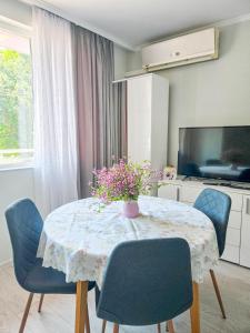 a dining room with a table and blue chairs at Guest House Medusa - Old town in Pomorie