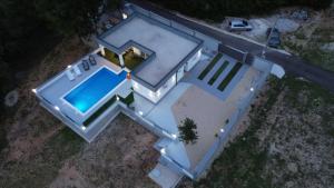 an overhead view of a house with a swimming pool at Villa Martar in Mostar