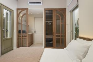 a bedroom with a bed and a door to a closet at Bliss House in Rethymno