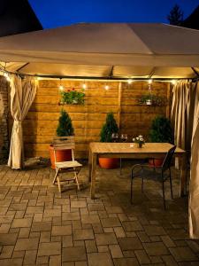 a table and chairs under a tent with lights at Pensiune Family & Friends Crit 168 in Criţ +29 photos