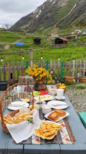 a table with plates of food on top of it at Hotel-restaurant Stumari in Ushguli