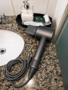 a flashlight sitting on a counter next to a sink at Apartamento 2 Quartos Moderno in Belo Horizonte