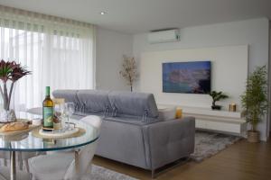 a living room with a couch and a glass table at Luxury by the Blue in Vila Nova de Gaia