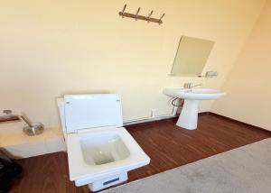 a bathroom with a toilet and a sink at Marshall in Termiz