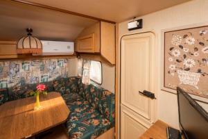a living room with a couch and a table in a trailer at Camping Little Oasis in Ezerets