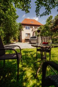 a table and chairs in a yard with a house at Willa Berg Cieplice in Jelenia Góra