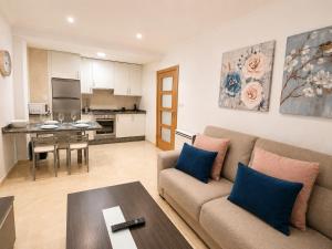 a living room with a couch and a table at Apartamento TIERRA in Viveiro +13 photos