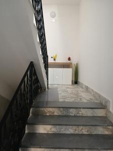 a staircase leading up to a white wall with a stair case at Victoria Home in Eboli +1 photo