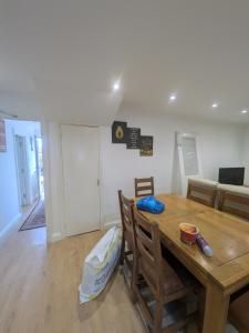 a dining room with a wooden table and chairs at 6 bedroom house Trochetia in Crawley +29 photos