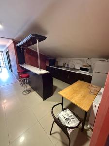 a kitchen with a wooden table and a counter top at Home in Mtskheta in Mtskheta