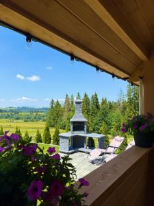 a view from the porch of a house with a gazebo at Apartament Bioło Izba in Czerwienne