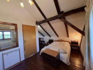 a bedroom with a bed in a room with beams at Villa Rustica in Hruškovica +9 photos