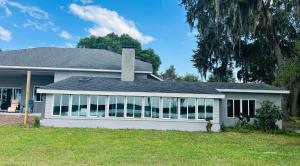 a house with a large screened in porch at Cozy Lake Front Cottage in Clermont