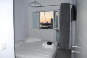 a white bed in a room with a window at Busho Residence 1 in Naousa