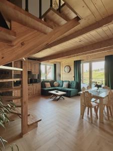 a living room with a couch and a table at Apartament Bioło Izba in Czerwienne