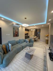 a large living room with a couch and a table at Bellagio Two Bedroom with Balcony in Kwedonu