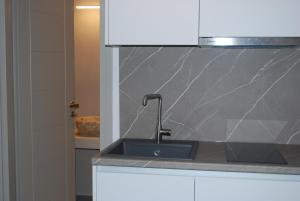 a kitchen with a sink and a counter top at Busho Residence 2 in Naousa +31 photos