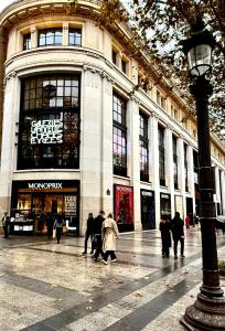a group of people walking in front of a building at Champs elysees apartment 4 in Paris