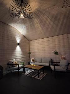 a living room with a couch and a table at Wooden House Kaszuby in Borsk