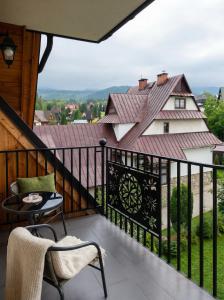 a balcony with a view of a house at Villa Taternik - Studio Apartment - Mountain View in Zakopane
