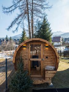 a large wooden hobbit house in a yard at Villa Taternik - Studio Apartment - Mountain View in Zakopane +10 photos
