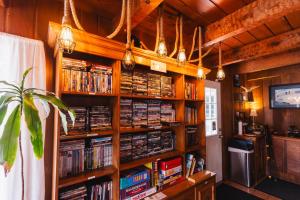 a library filled with book shelves filled with dvds at Tillicum Beach Motel - Formerly Deane's Oceanfront Lodge in Yachats