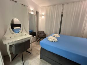 a bedroom with a bed and a mirror and a chair at Villa Legacy with privat heating pool in Novalja +12 photos
