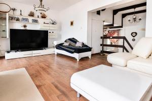 a living room with a flat screen tv and a couch at Villa Bellevue Amazing Sea View 7 Guests in Krašići