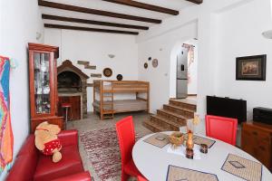a living room with a table and red chairs at Villa Bellevue Amazing Sea View 7 Guests in Krašići