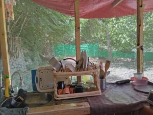 a kitchen counter with a container of cooking utensils at Cottage De Hunza- A Soul Retreat Sanctuary in Hunza Valley