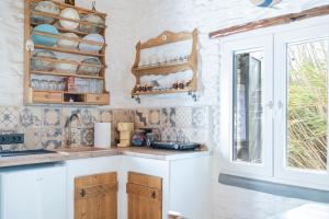 a kitchen with wooden cabinets and a counter top at Aloni Houses Kythnos in Loutra +71 photos