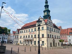a building with a clock tower on top of it at Altstadt Loft - Im Herzen der Altstadt - TREVIET in Pirna