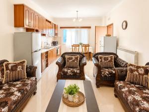 a living room with two couches and a table at Countryside Villa in Vlorë