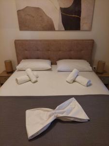 a bed with two white robes on top of it at Μοντέρνο Σπίτι in Monemvasia