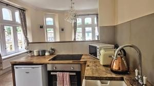 a kitchen with a counter top with a microwave at Palace View Apartment in Buxton