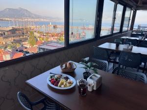 a bowl of fruit on a table in a restaurant at Temiz Hotel in Alanya +30 photos