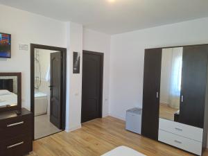 a room with two black doors and a mirror at Pensiunea Turist in Techirghiol +52 photos