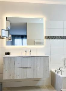 a bathroom with a sink and a large mirror at KeschtaLoft - Gîte classé 4 étoiles in Châtenois +47 photos