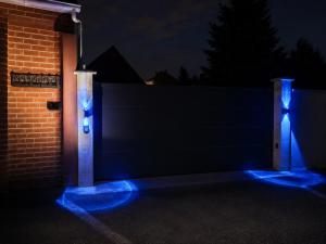 a fence with blue lights on it at night at BLOM Spa privatif près de Douai, salle de massage, petit-déjeuner inclus in Guesnain