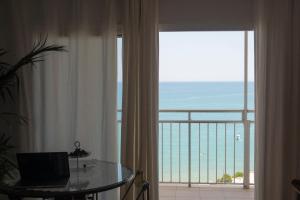 a room with a window with a view of the ocean at Comfortable and Elegant Seafront Apartment in Faro de Cullera
