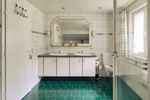 a bathroom with two sinks and a mirror at Haus Bergharmonie in Tschagguns +63 photos