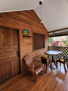 a room with a table and chairs and a door at Ballena Oasis Homes & Glamping in Uvita