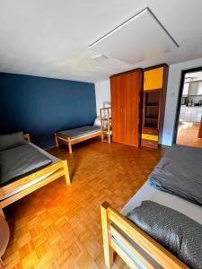 a room with two beds and a wooden floor at Signature events in Malečnik