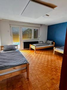 a bedroom with two beds and a wooden floor at Signature events in Malečnik