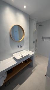 a bathroom with a sink and a mirror at Myrto Hotel in Kamares