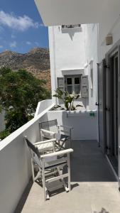 a balcony with chairs and a table on a building at Myrto Hotel in Kamares +64 photos