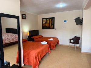 a hotel room with two beds and a mirror at Terracota Corner Rooms in Campeche +132 photos