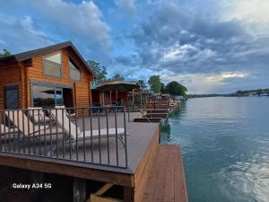 a wooden house on a dock on a lake at Mimas HOUSE ADA BOJANA in Ulcinj