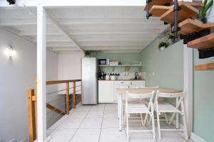 a kitchen with a table and chairs and a refrigerator at S-HE Space - Budget Micro Rooms Kraków in Krakow +12 photos